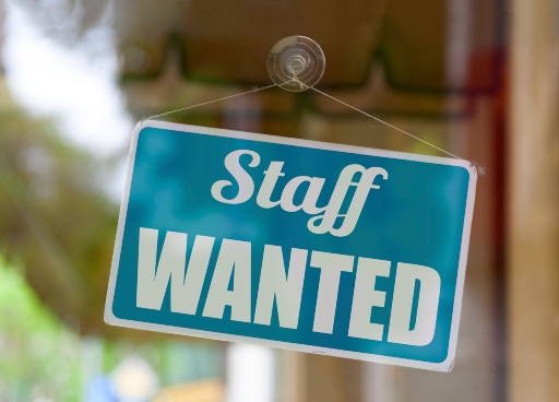 Staff Wanted sign in a window